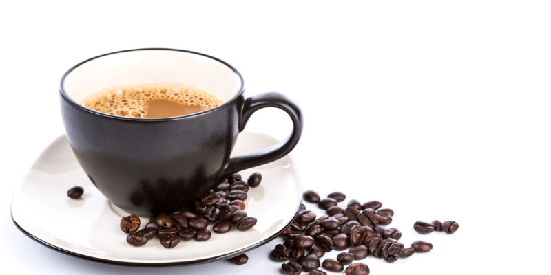 Coffee cup and beans on a white background